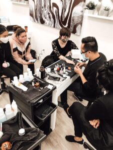 A man doing nail work on a woman's nails