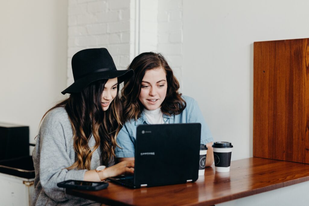 Two girl s working on laptop